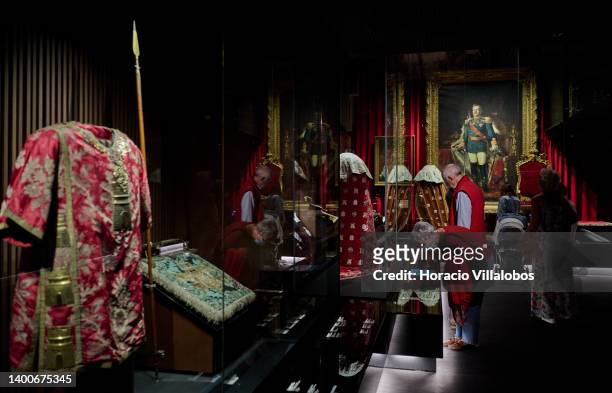 Visitors look at royal robes at the Royal Treasure Museum in Ajuda National Palace on June 02, 2022 in Lisbon, Portugal. The Museu do Tesouro Real is...