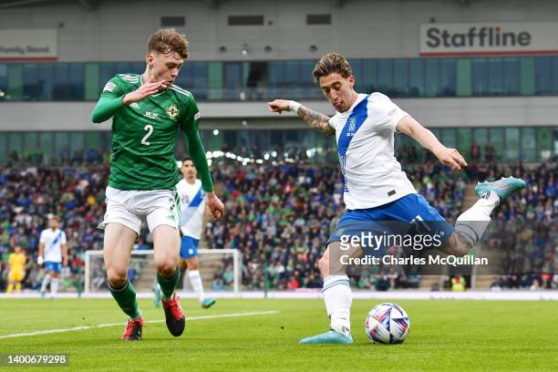 Konstantinos Tsimikas of Greece looks to cross the ball whilst under pressure from Conor Bradley of Northern Ireland during the UEFA Nations League...