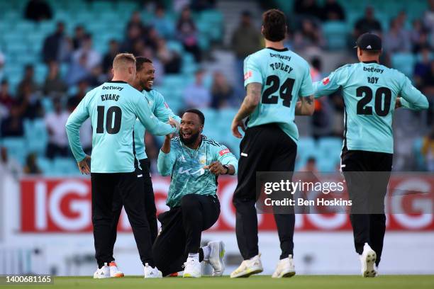 Kieron Pollard of Surrey celebrates with team mates after taking the wicket of Nick Gubbins during the Vitality T20 Blast match between Surrey and...