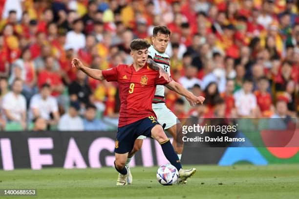 Gavi of Spain battles for possession with Octavio of Portugal during the UEFA Nations League League A Group 2 match between Spain and Portugal at...