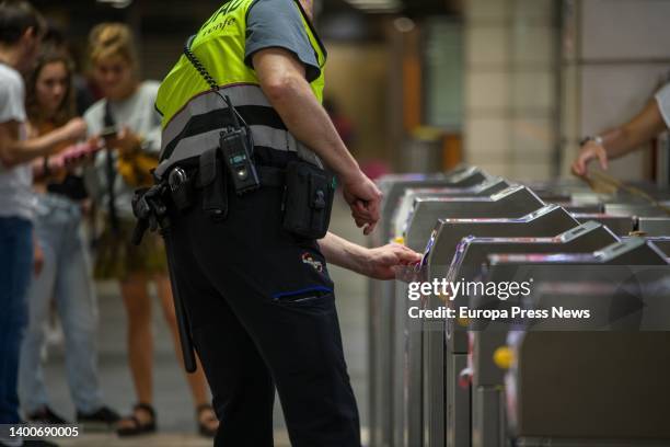 Security guard fixes damage at the Plaça de Catalunya metro station from a demonstration by the Batec youth collective, June 2 in Barcelona,...