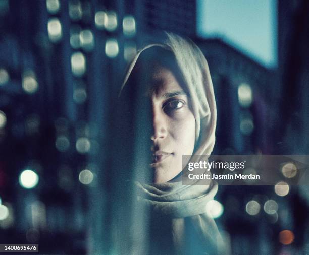 reflection portrait of muslim woman on night city street - saudi arabia women stock pictures, royalty-free photos & images