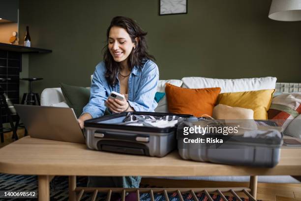 woman using laptop to book travel reservation - making a voyage stock pictures, royalty-free photos & images