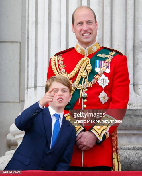 Prince George of Cambridge and Prince William, Duke of Cambridge watch a flypast from the balcony of Buckingham Palace during Trooping the Colour on...