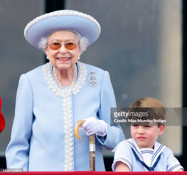 Queen Elizabeth II and Prince Louis of Cambridge watch a flypast from the balcony of Buckingham Palace during Trooping the Colour on June 2, 2022 in...
