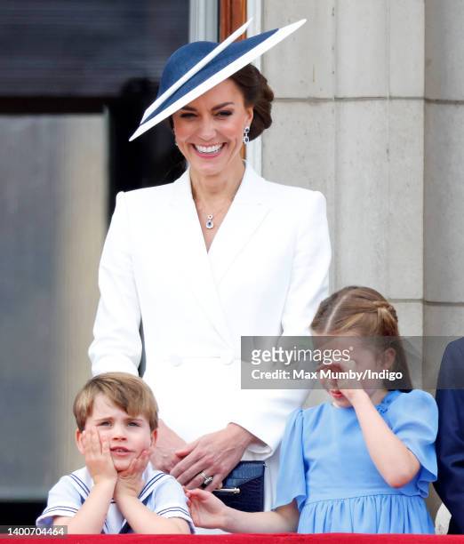 Prince Louis of Cambridge, Catherine, Duchess of Cambridge and Princess Charlotte of Cambridge watch a flypast from the balcony of Buckingham Palace...