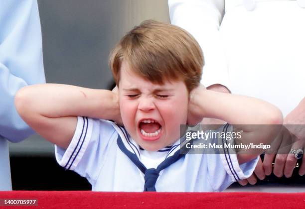 Prince Louis of Cambridge covers his ears whilst watching a flypast from the balcony of Buckingham Palace during Trooping the Colour on June 2, 2022...