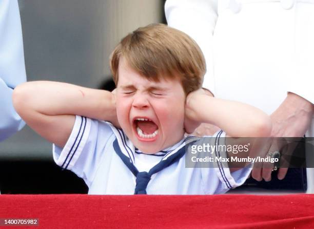Prince Louis of Cambridge covers his ears whilst watching a flypast from the balcony of Buckingham Palace during Trooping the Colour on June 2, 2022...