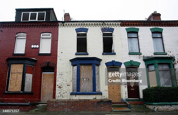 Metal shutters are used to cover windows and doors of houses marked for a housing regeneration project in the Anfield district of Liverpool, U.K., on...