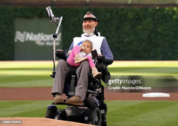 Steve Gleason, a sufferer of Amyotrophic Lateral Sclerosis , holds his daughter Gray, 3 while watching his son Rivers throws the ceremonial first...