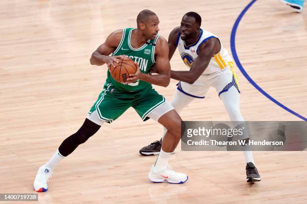 Al Horford of the Boston Celtics looks to pass the ball against Draymond Green of the Golden State Warriors during the first quarter in Game One of...