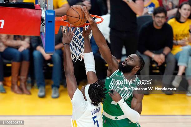 Jaylen Brown of the Boston Celtics blocks the shot attempt by Kevon Looney of the Golden State Warriors during the first quarter in Game One of the...