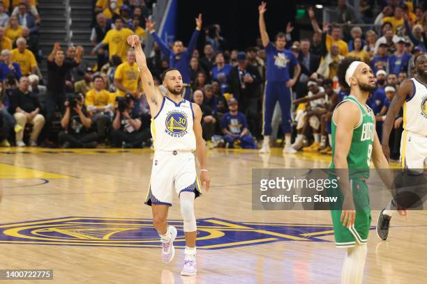 Stephen Curry of the Golden State Warriors reacts after a made three point basket against the Boston Celtics during the first quarter in Game One of...
