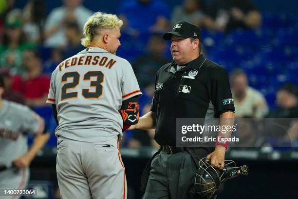 Joc Pederson of the San Francisco Giants talks with home plate umpire Doug Eddings after being called out on strikes in the sixth inning against the...