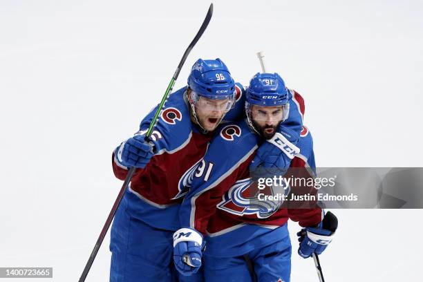 Mikko Rantanen and Nazem Kadri of the Colorado Avalanche celebrate a goal scored by Artturi Lehkonen on Mike Smith of the Edmonton Oilers during the...