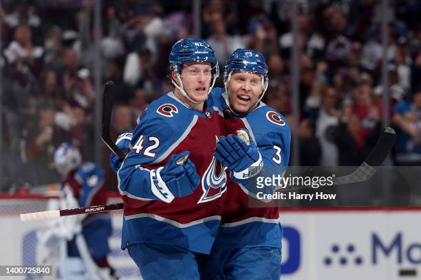 Josh Manson of the Colorado Avalanche celebrates with teammate Jack Johnson after scoring a goal on Mike Smith of the Edmonton Oilers during the...
