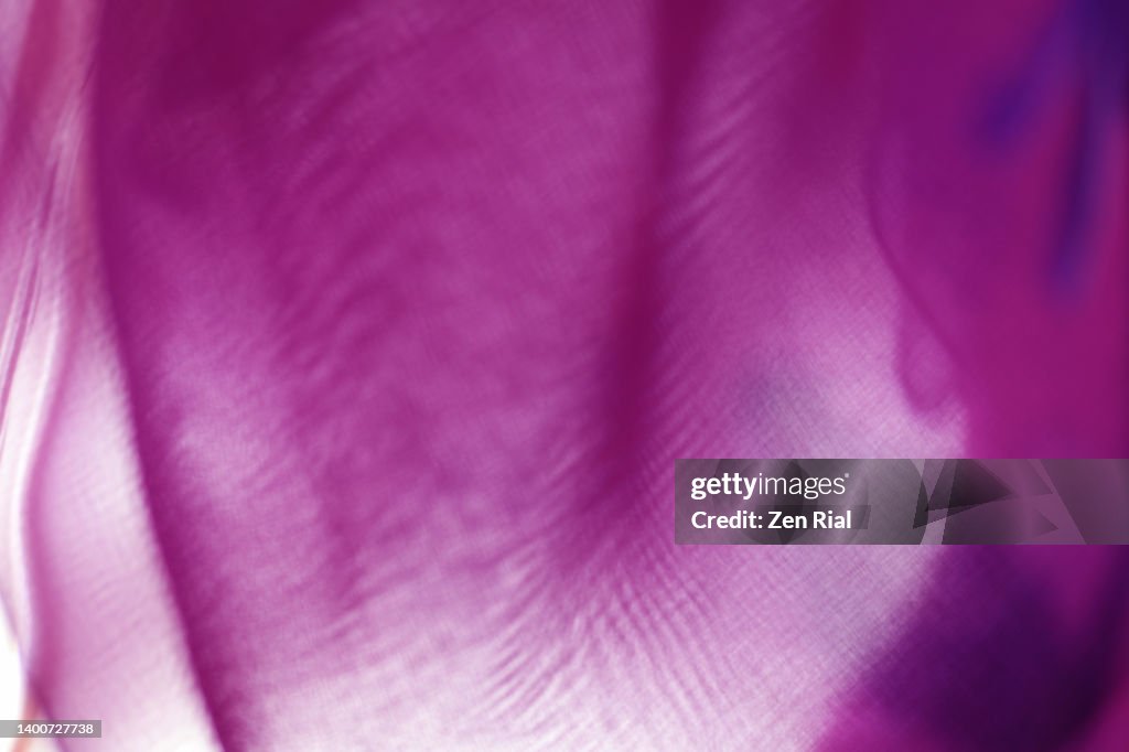 Back lit abstract purple magenta with touch of blue fabric