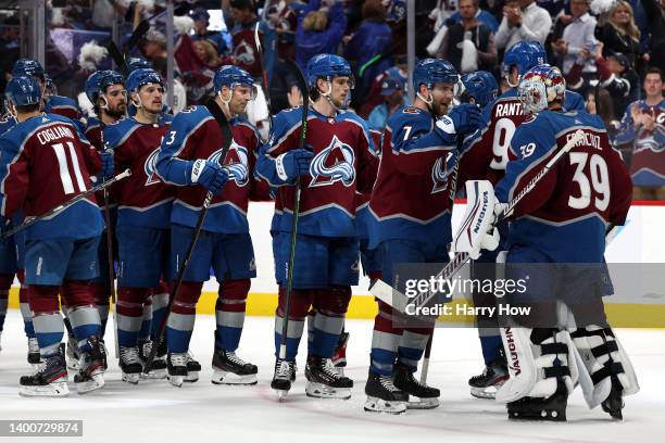 Devon Toews and Pavel Francouz of the Colorado Avalanche celebrate after defeating the Edmonton Oilers with a score of 4 to 0 in Game Two of the...