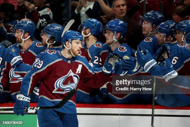 Nathan MacKinnon of the Colorado Avalanche celebrates with his teammates after scoring a goal on Mike Smith of the Edmonton Oilers during the third...