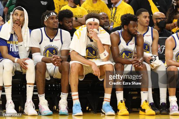 Otto Porter Jr. #32, Kevon Looney, Klay Thompson, Andrew Wiggins, and Jordan Poole of the Golden State Warriors look on from the bench during the...