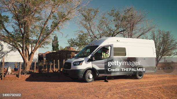 delivering man getting out of his van in rural utah - mini van stock pictures, royalty-free photos & images