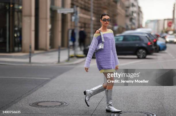 Celine Bethmann wearing Jacquemus silver bag, selfmade knit sweater, black shades and Topshop silver boots on May 31, 2022 in Berlin, Germany.
