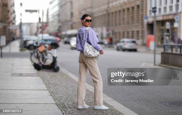 Celine Bethmann wearing Balenciaga Le Carole bag, Polo Ralph Lauren lilac Sweater, white Adidas Forum sneaker, black Versace shades and beige Zara...