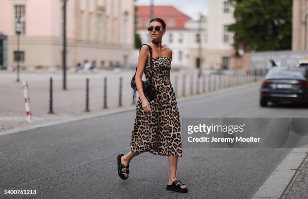 Celine Bethmann wearing Versace Jeans couture black gold sandals, Zara animal print dress, Bottega Veneta shades and Balenciaga Le Cagole black bag...
