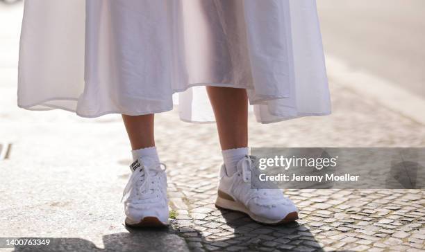 Lena Naumann wearing New Balance x Miu Miu white sneaker, Cecilie Bahnsen white maxi dress on May 31, 2022 in Berlin, Germany.