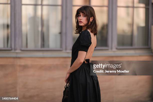 Lea Naumann wearing black midi dress, Dior black Lady bag on May 31, 2022 in Berlin, Germany.