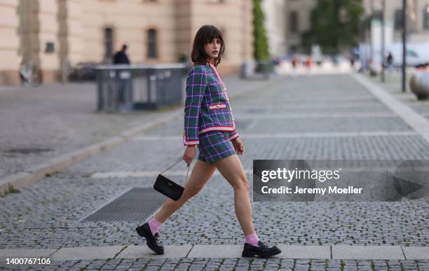 Lea Naumann wearing Gant matching two piece, rose socks, Gucci black loafer, Prada black leather mini bag on May 31, 2022 in Berlin, Germany.