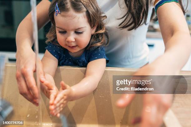 washing baby's hands - hand washing stockfoto's en -beelden