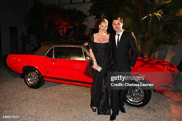 Actress Natasha Henstridge and singer-songwriter Darius Campbell pose with a Ford Mustang at the Maxim late night party with Ford Mustang Customizer...