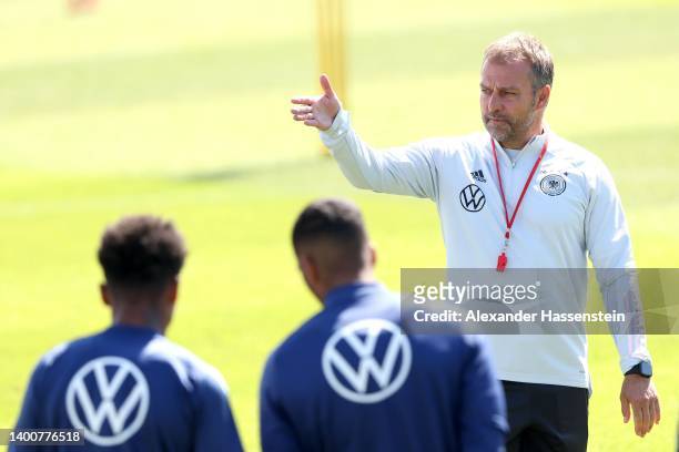 Head coach Hans-Dieter Flick talks to his players during a training session of the German national soccer team at Adi-Dassler-Stadion of adidas Herzo...