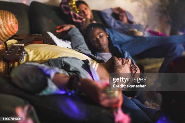 drunk friends fell asleep after party at home. - hangover stockfoto's en -beelden