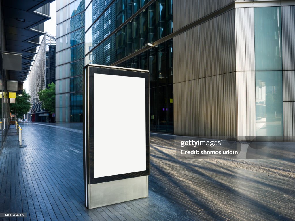 Blank digital billboard amidst modern buildings in London