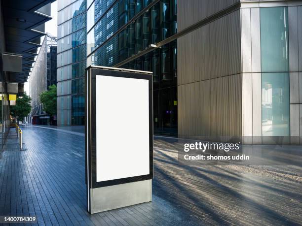 blank digital billboard amidst modern buildings in london - poster blank stock-fotos und bilder