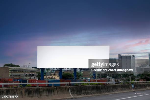 blank billboard for outdoor advertising poster on the highway - billboard night photos et images de collection