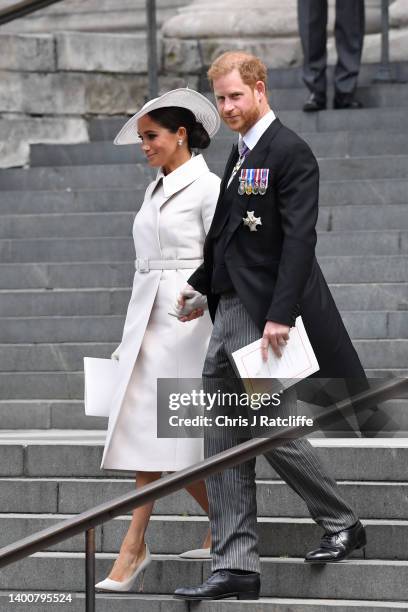 Prince Harry, Duke of Sussex, and Meghan, Duchess of Sussex depart the National Service of Thanksgiving at St Paul's Cathedral on June 03, 2022 in...