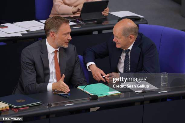 German Chancellor Olaf Scholz and Finance Minister Christian Lindner speak with one another prior to votes on both a constitutional amendment that...