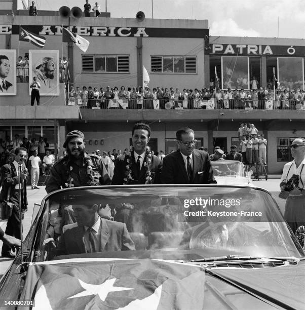 President of Algerian council Ahmed Ben Bella in the official convertible car with Fidel Castro and the president of Cuba Osvaldo Dorticos, on...