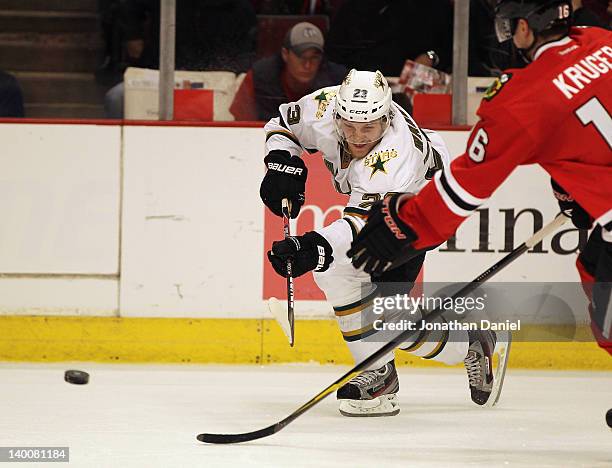 Tom Wandell of the Dallas Stars passes the puck against Marcus Kruger of the Chicago Blackhawks at the United Center on February 23, 2012 in Chicago,...