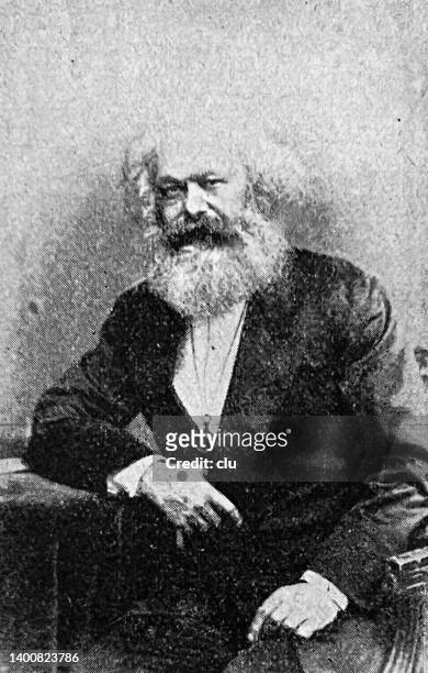 karl marx sitting on a chair, leaning on table - karl marx stock illustrations