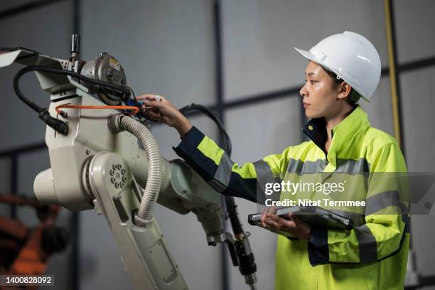 monitor utilization and capacity of manufacturing equipment. a female cost control engineer in the robotics welding line and using a tablet to monitoring machine utilization for review overall equipment effectiveness to improve utilization rate. - digital mining stock pictures, royalty-free photos & images