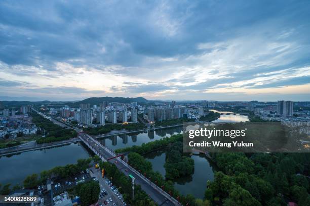 skyline of xinyang city, henan province, china at dusk - henan province foto e immagini stock