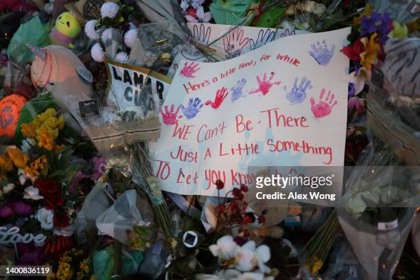 Flowers and posters are placed at a memorial dedicated to the victims of the mass shooting at Robb Elementary School on June 3, 2022 in Uvalde,...