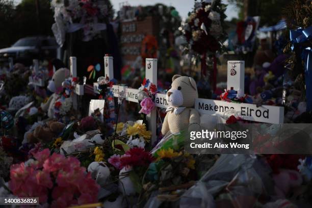 Flowers, plush toys and wooden crosses are placed at a memorial dedicated to the victims of the mass shooting at Robb Elementary School on June 3,...