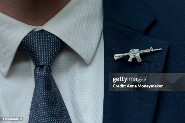 Congressional staffer wears a rifle shaped pin on his suite during a House Judiciary Committee mark up hearing in the Rayburn House Office Building...