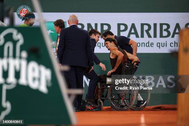 Alexander Zverev of Germany is wheeled off in a wheelchair following an injury against Rafael Nadal of Spain during the Men's Singles Semi Final...