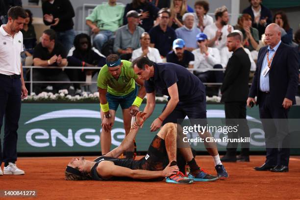 Alexander Zverev of Germany receives medical attention following an injury against Rafael Nadal of Spain during the Men's Singles Semi Final match on...